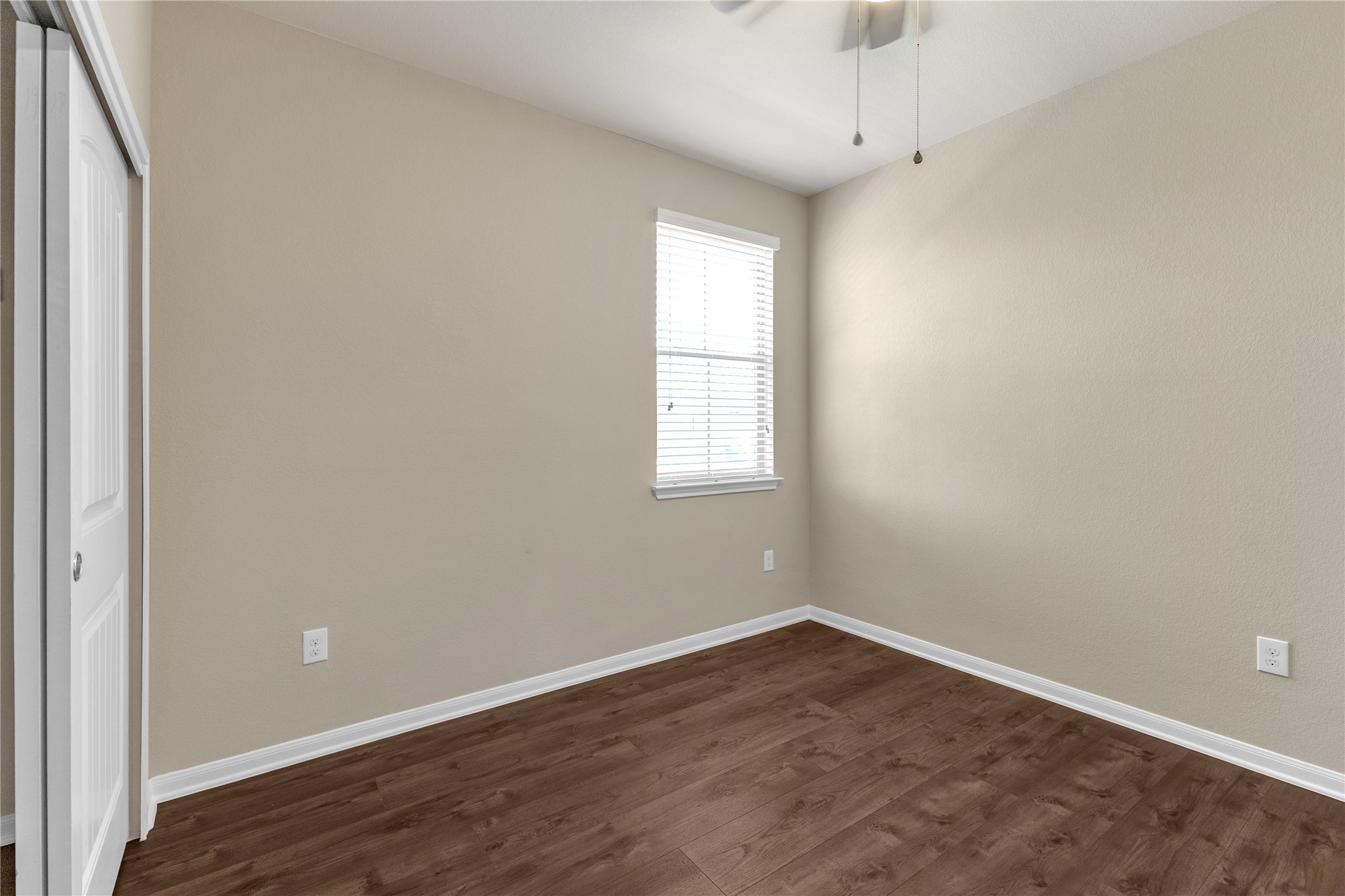 2880 Donnell Drive, Unit 2003 Round Rock, TX 78664 - Photo 22 of 31 Bedroom featuring wood-finish flooring, a window with blinds, and neutral wall tones