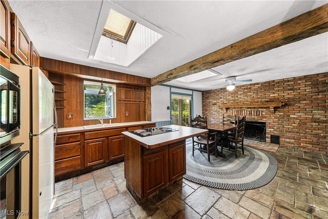 11828 Sheldon Road Mantua, OH 44255 - Photo 6 of 31 Expansive eat-in kitchen with slate floors, a skylight, Kraftmaid cabinets and woodburning fireplace