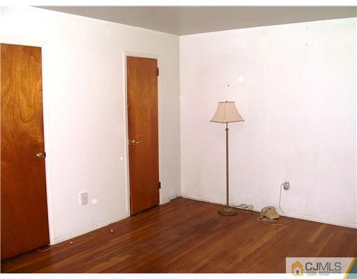 3 Ellmyer Road Edison, NJ 08820 - Photo 12 of 18 a bedroom with a bed and a lamp