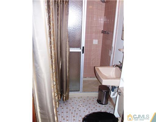 3 Ellmyer Road Edison, NJ 08820 - Photo 13 of 18 a bathroom with a sink and a mirror