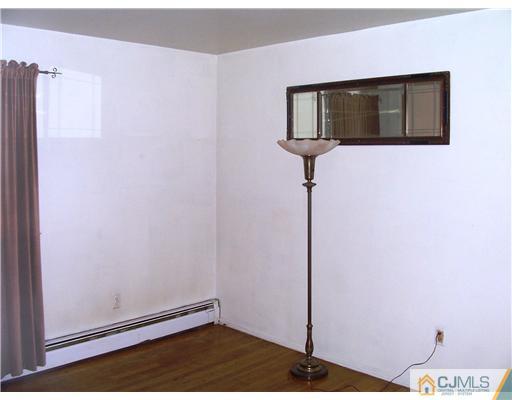 3 Ellmyer Road Edison, NJ 08820 - Photo 14 of 18 a view of a hallway with wooden floor