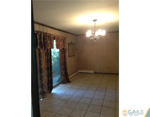 3 Ellmyer Road Edison, NJ 08820 - Photo 6 of 18 a view of a hallway with chandelier
