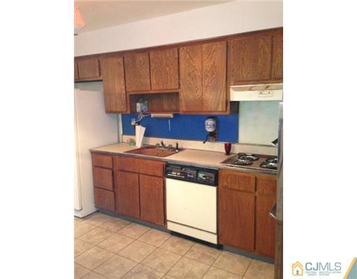 3 Ellmyer Road Edison, NJ 08820 - Photo 8 of 18 a kitchen with stainless steel appliances a stove a sink and a refrigerator