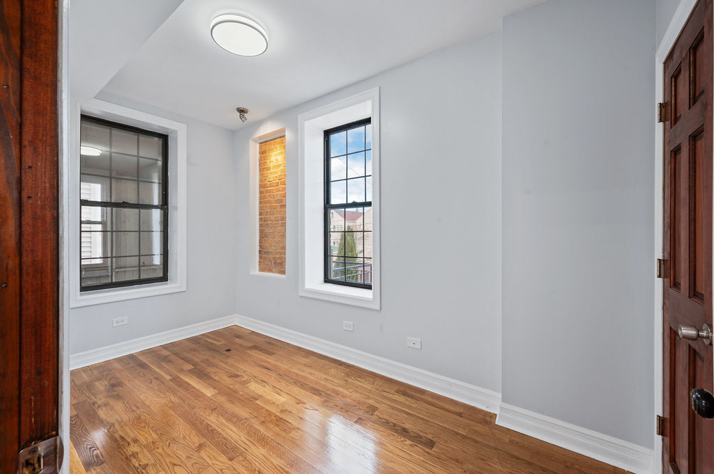 3100 West 39th Place Chicago, IL 60632 - Photo 12 of 36 an empty room with wooden floor and windows