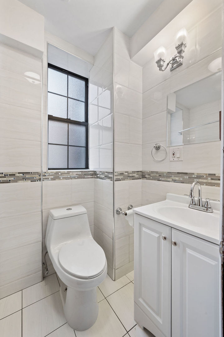 3100 West 39th Place Chicago, IL 60632 - Photo 17 of 36 a bathroom with a granite countertop toilet sink and mirror