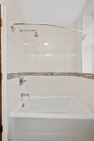 a bathroom with a tub and a shower