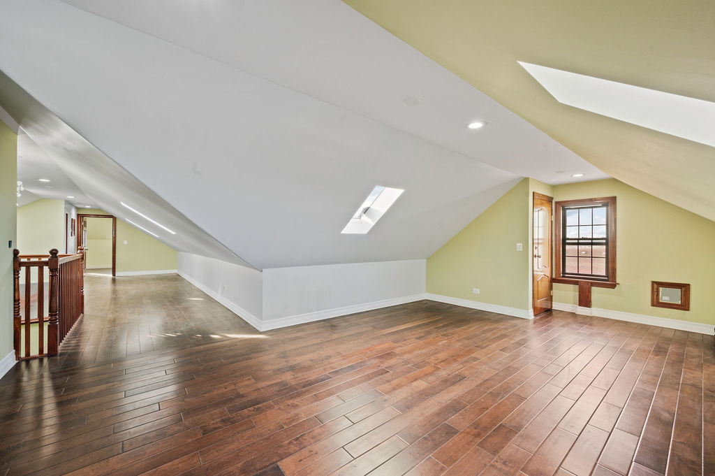 3100 West 39th Place Chicago, IL 60632 - Photo 22 of 36 a view of an empty room with wooden floor and a window