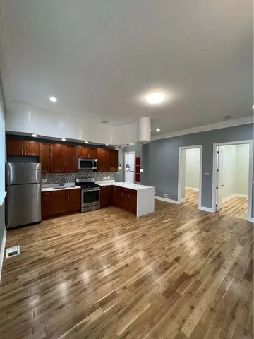 a view of kitchen with kitchen island and stainless steel appliances