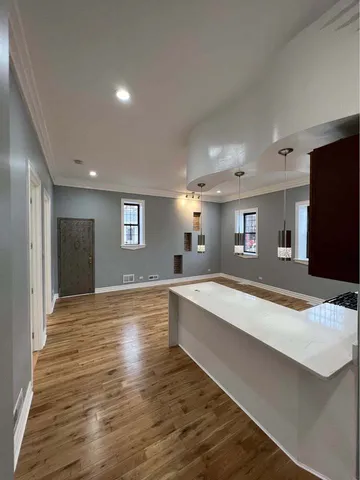 a room with wooden floor and window