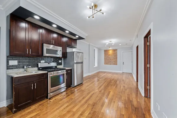 a open kitchen with a stove a sink dishwasher and a refrigerator