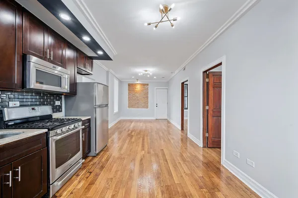 a view of kitchen with sink and wooden floor