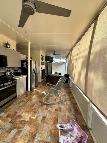 a kitchen with stainless steel appliances a stove a sink and a refrigerator