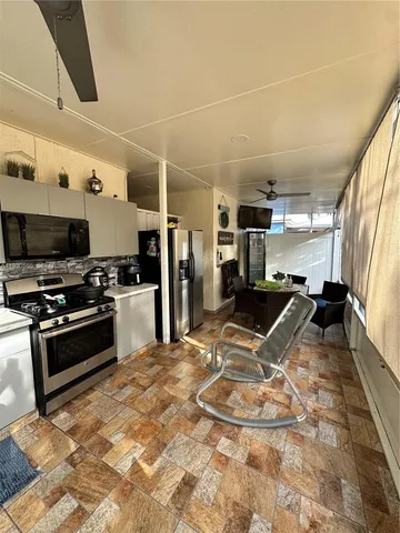 a kitchen with stainless steel appliances kitchen island granite countertop a sink stove and refrigerator