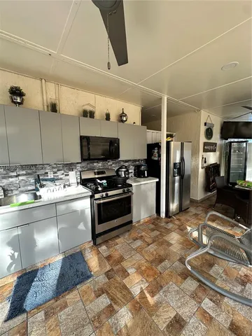 a kitchen with stainless steel appliances a stove a sink and a refrigerator