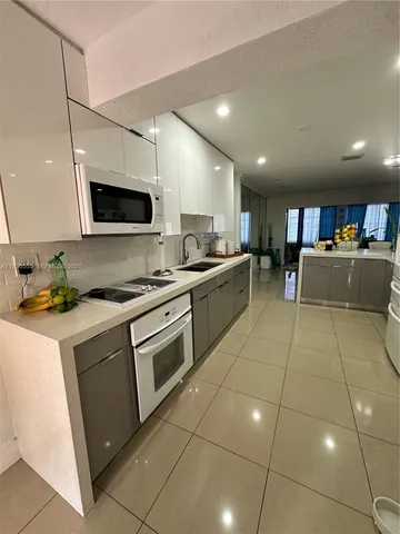 a kitchen with stainless steel appliances granite countertop a sink and cabinets