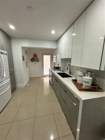 a room with gym equipment and refrigerator