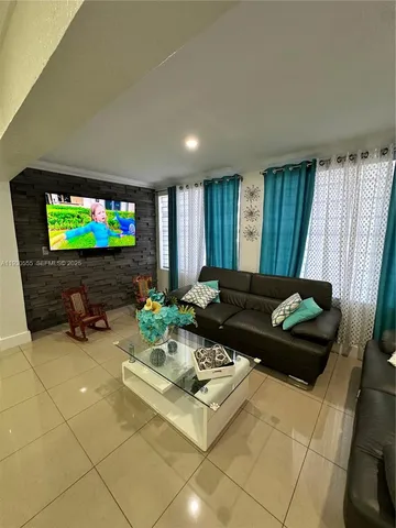 a lobby with a couch and a view of living room