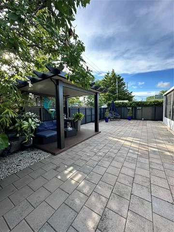 a view of a backyard with sitting area