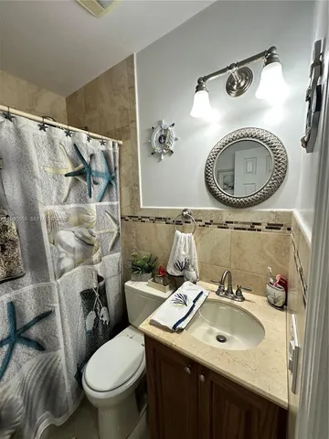 a bathroom with a shower and a toilet