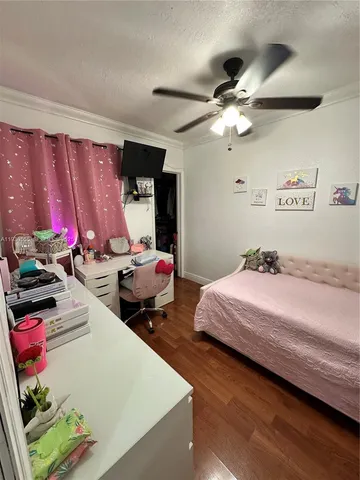 a bed room with a bed mirror and a window