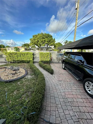 a view of a backyard with swimming pool