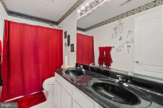 a bedroom with a bed and flat screen tv