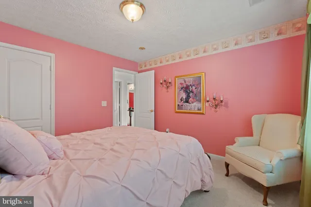 a bedroom with furniture and a mirror