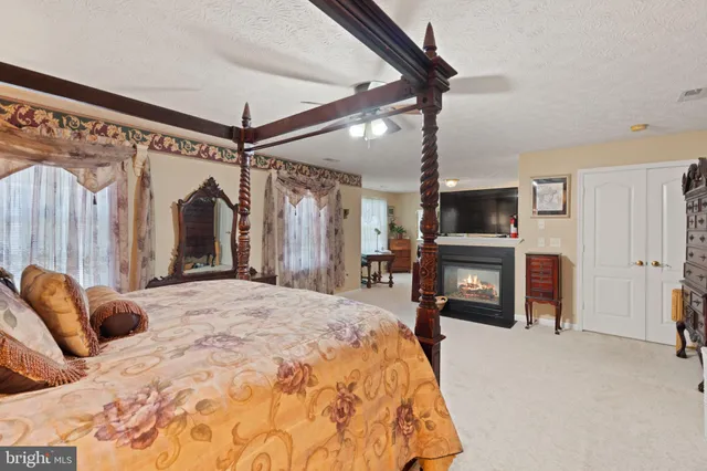 a bedroom with furniture and a large window