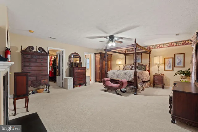 a bedroom with furniture and a fireplace