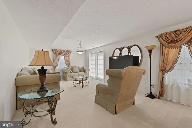 a dining room with furniture and a chandelier