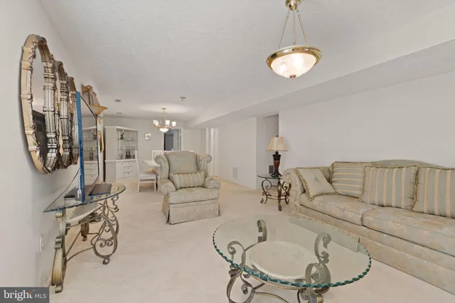 a view of dining room and kitchen with furniture a chandelier and wooden floor