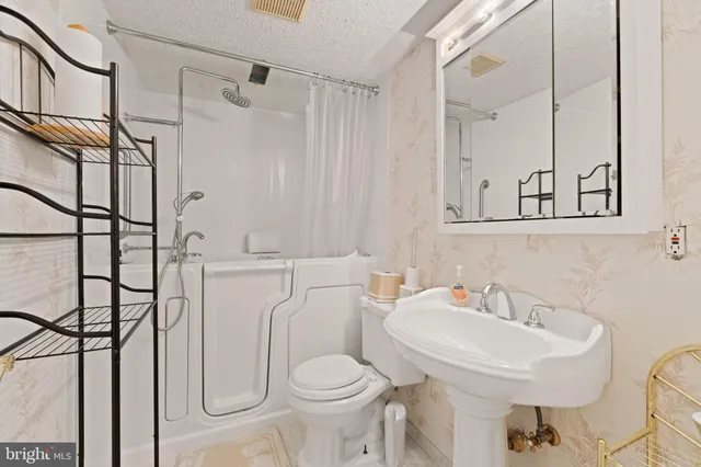 a bedroom with a bed next to a window