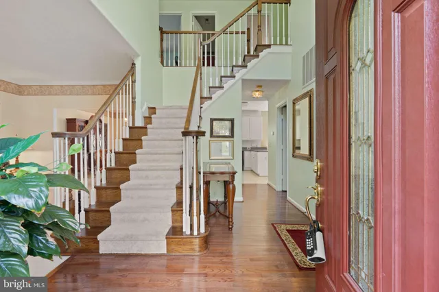 a view of entryway and hall with wooden floor