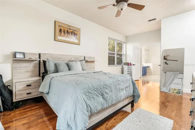 a spacious bathroom with a tub sink and mirror