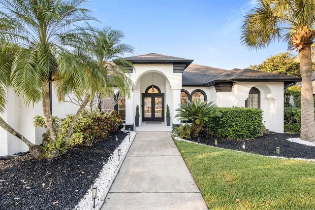 a front view of a house with a garden