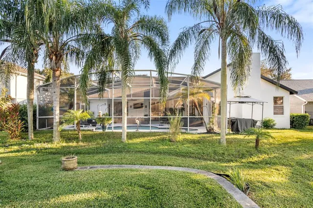 an aerial view of a house with a yard