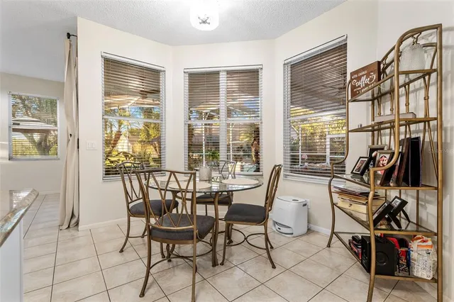 a kitchen with stainless steel appliances granite countertop a refrigerator a stove a sink dishwasher and white cabinets with wooden floor