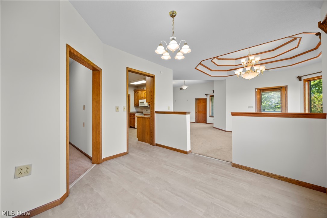 51488 Peck Wadsworth Road Wellington, OH 44090 - Photo 26 of 50 Open concept interior with light-tone flooring, white walls, and wood trim accents