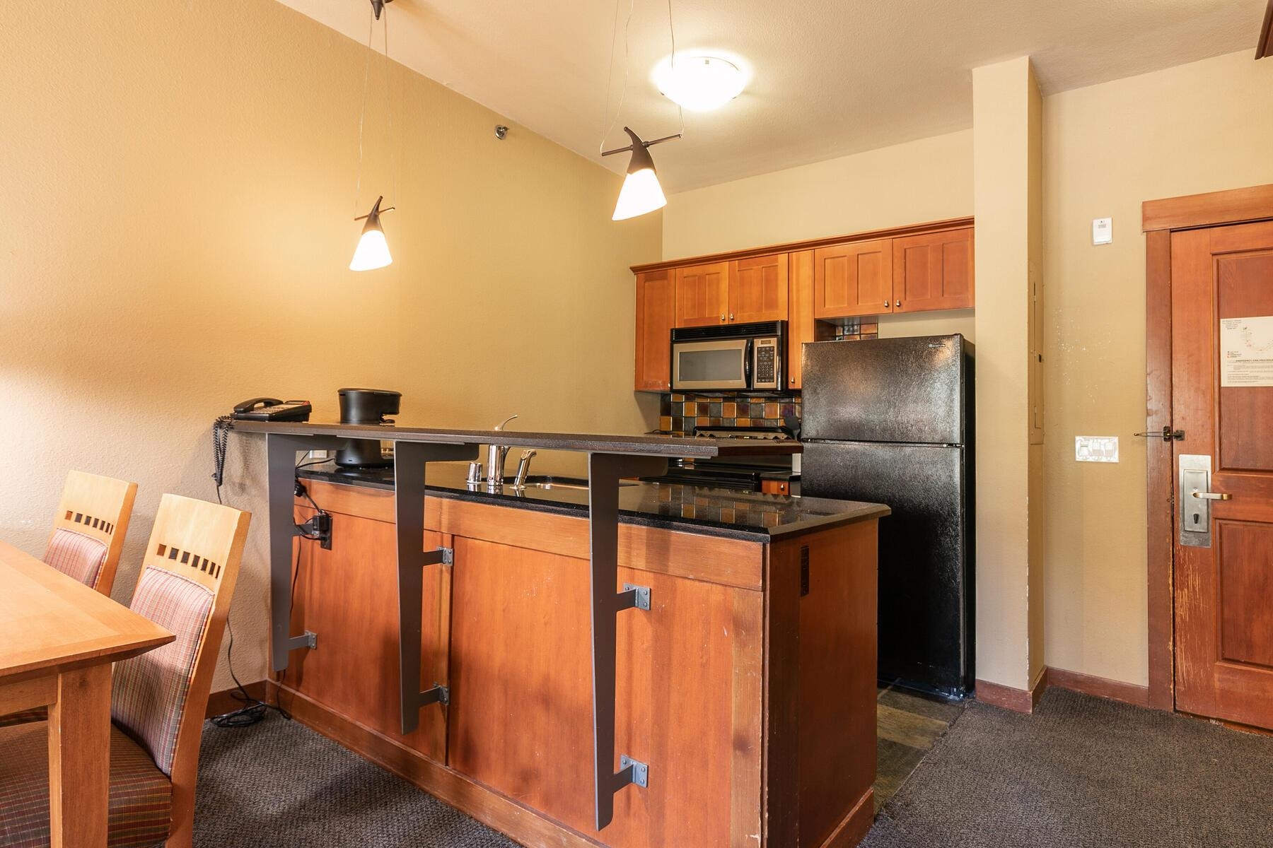 1850 Village South Road, Unit 4227 Olympic Valley, CA 96146 - Photo 14 of 21 a kitchen with stainless steel appliances granite countertop a refrigerator and a sink
