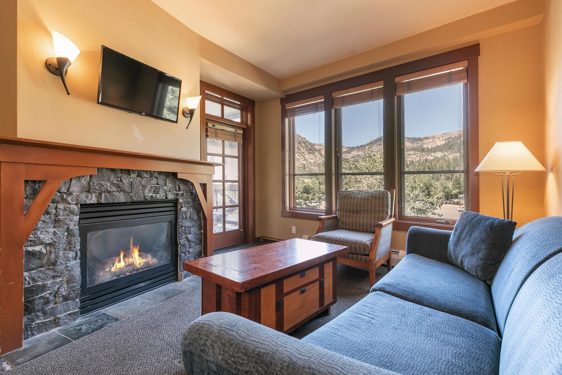 1850 Village South Road, Unit 4227 Olympic Valley, CA 96146 - Photo 15 of 21 a living room with furniture a flat screen tv and a fireplace