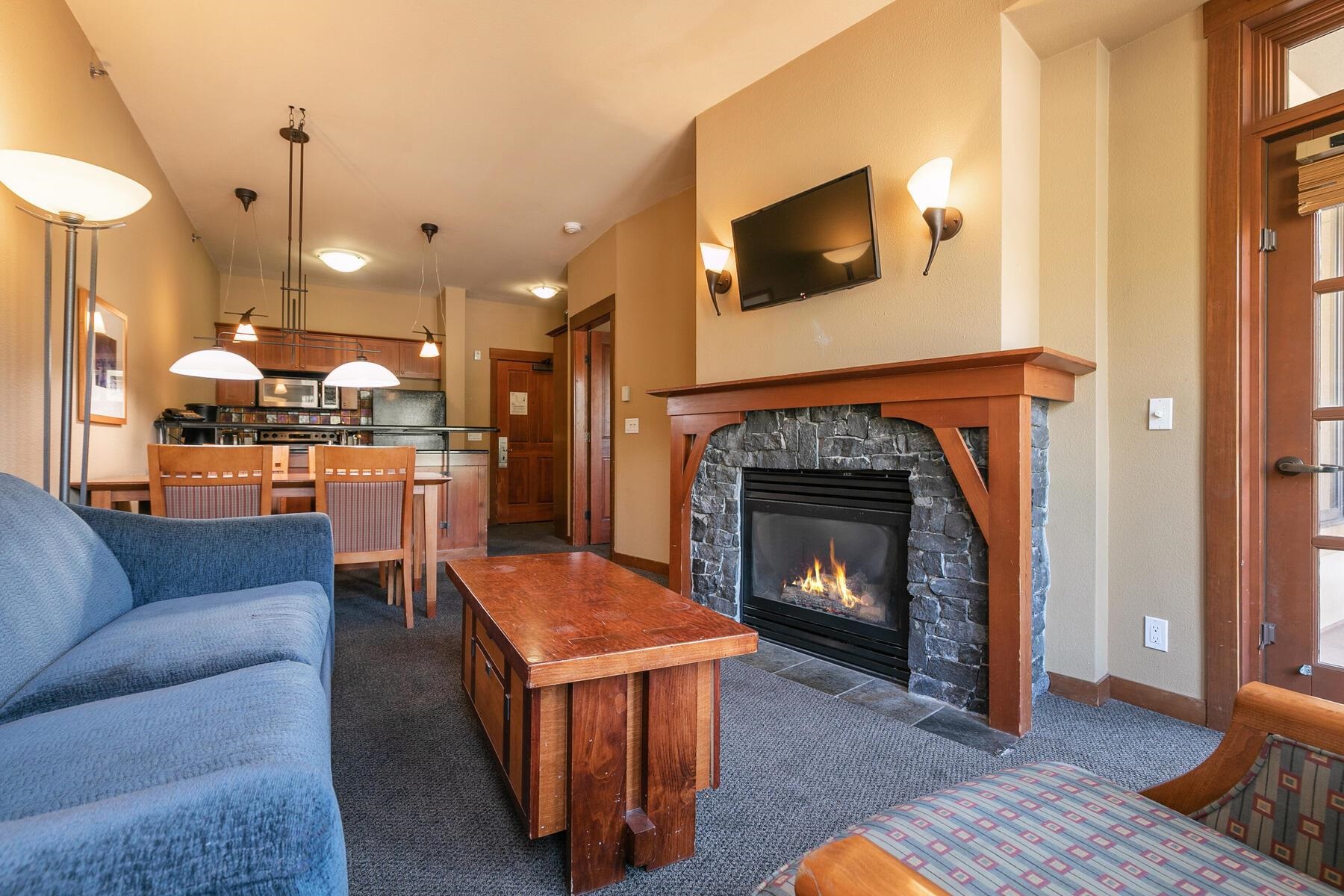 1850 Village South Road, Unit 4227 Olympic Valley, CA 96146 - Photo 6 of 21 a living room with furniture and a fireplace