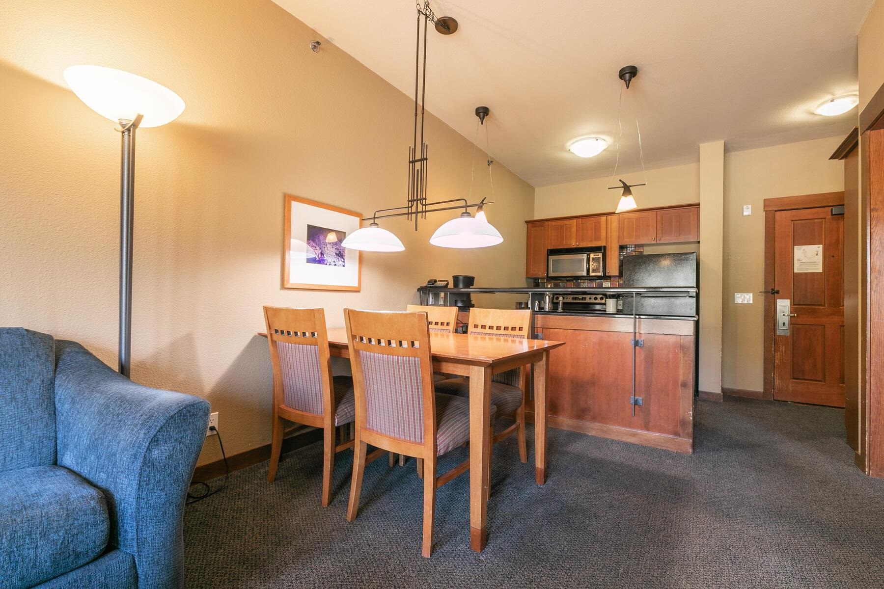 1850 Village South Road, Unit 4227 Olympic Valley, CA 96146 - Photo 7 of 21 a dining room with stainless steel appliances kitchen island granite countertop a table and chairs
