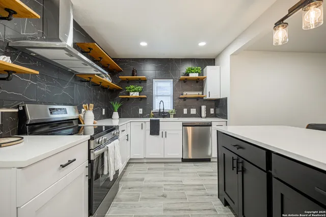 a kitchen with stainless steel appliances granite countertop a sink and cabinets