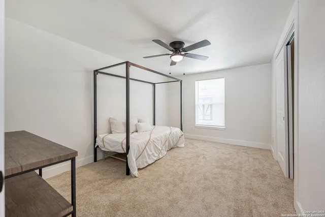 a bed room with a bed and a window