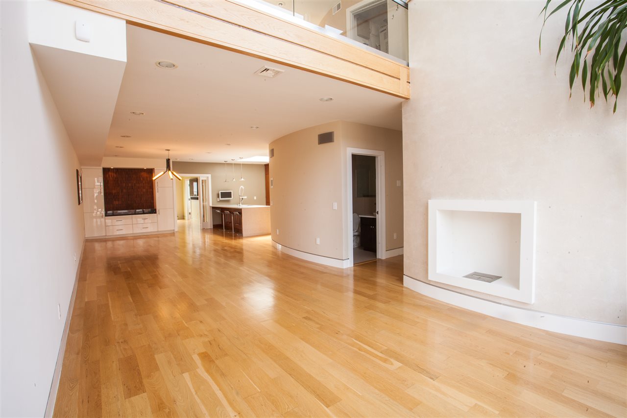a view of a living room with a fireplace