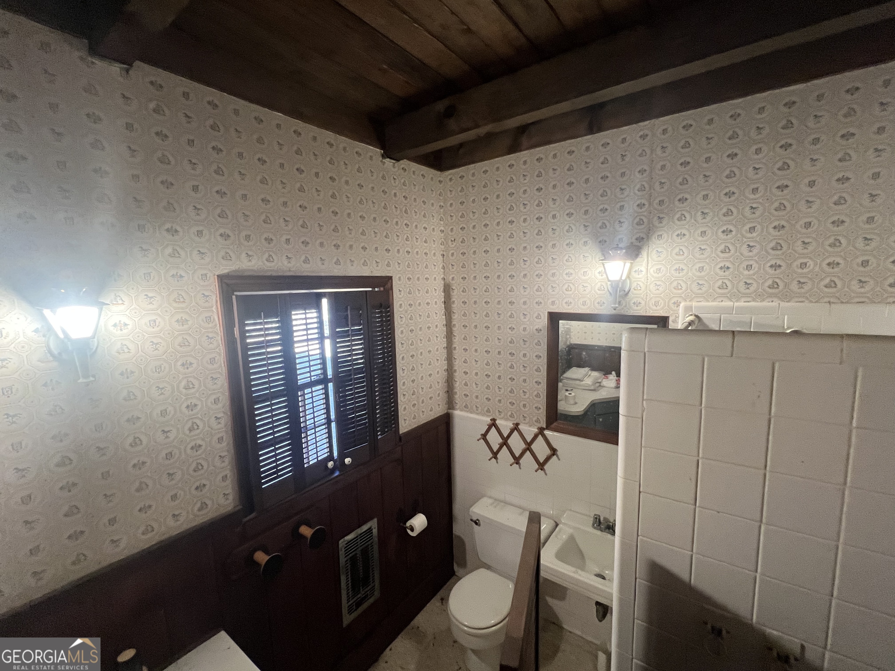 3140 Gees Mill Road Northeast Conyers, GA 30013 - Photo 15 of 17 a bathroom with a toilet a sink and mirror