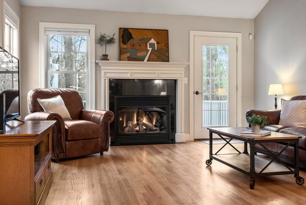 156 Canterbury Way, Unit 156 West Springfield, MA 01089 - Photo 11 of 32 a living room with furniture and a fireplace