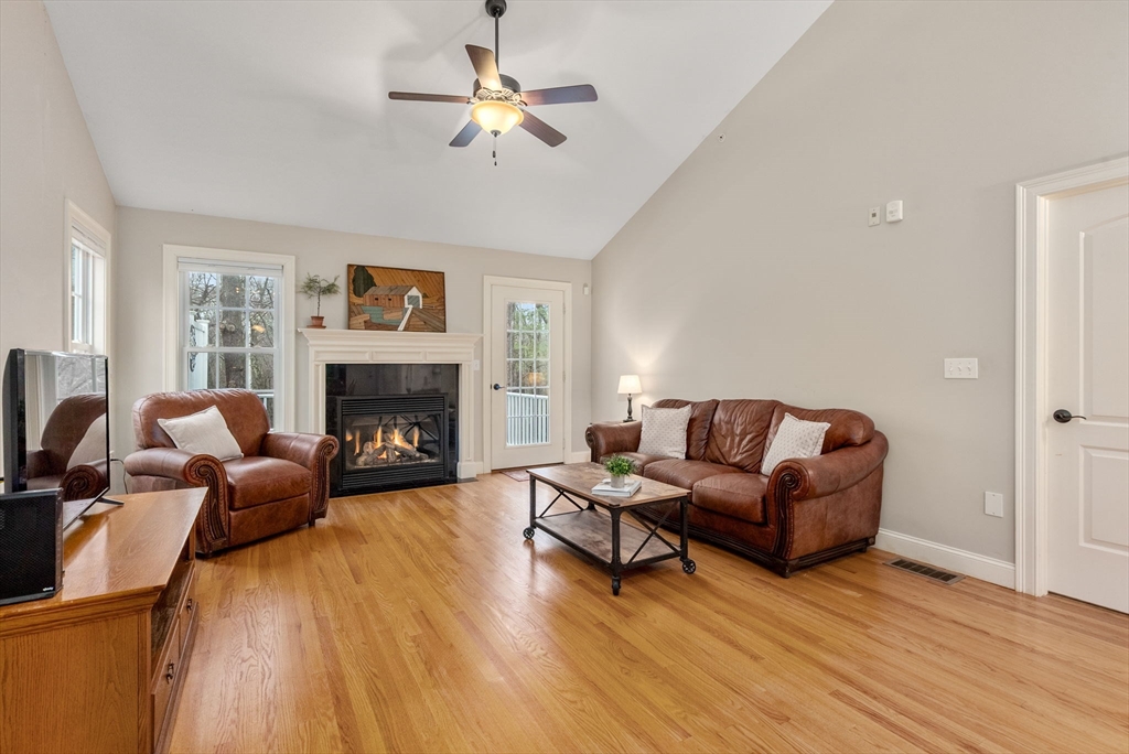 156 Canterbury Way, Unit 156 West Springfield, MA 01089 - Photo 12 of 32 a living room with furniture and a fireplace