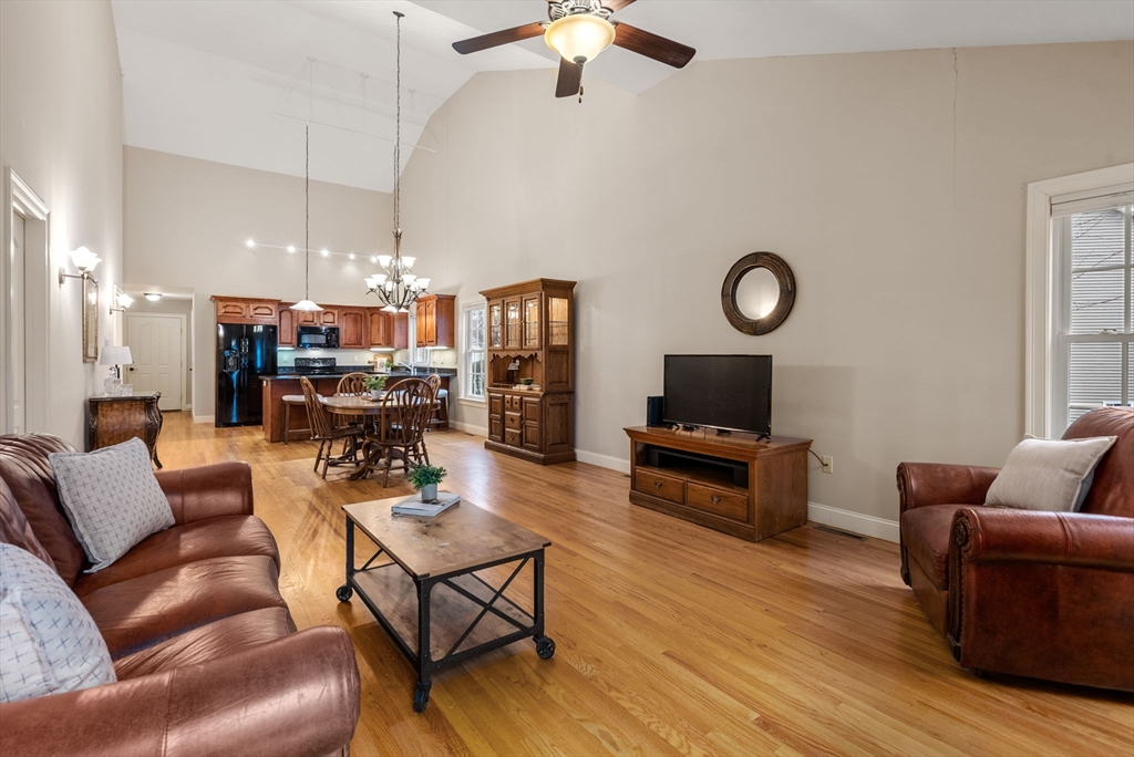 156 Canterbury Way, Unit 156 West Springfield, MA 01089 - Photo 14 of 32 a living room with furniture kitchen view and a chandelier