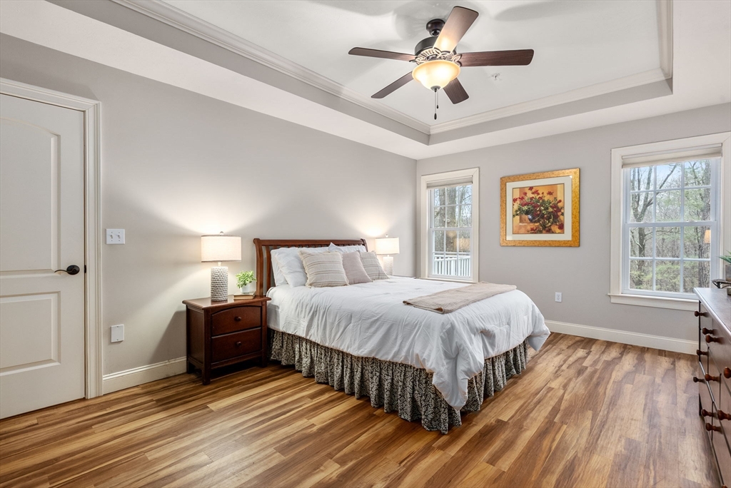 156 Canterbury Way, Unit 156 West Springfield, MA 01089 - Photo 15 of 32 a spacious bedroom with a bed and a ceiling fan